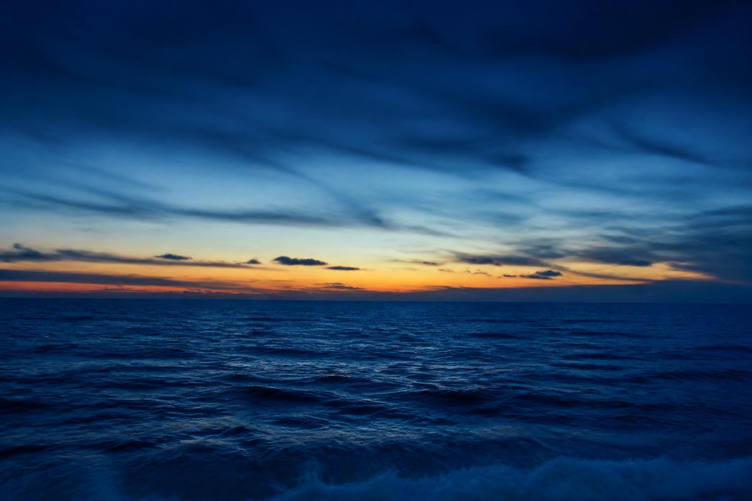 Deep blue ocean and sky after sunset